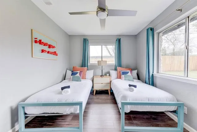 a bedroom with two beds and a window