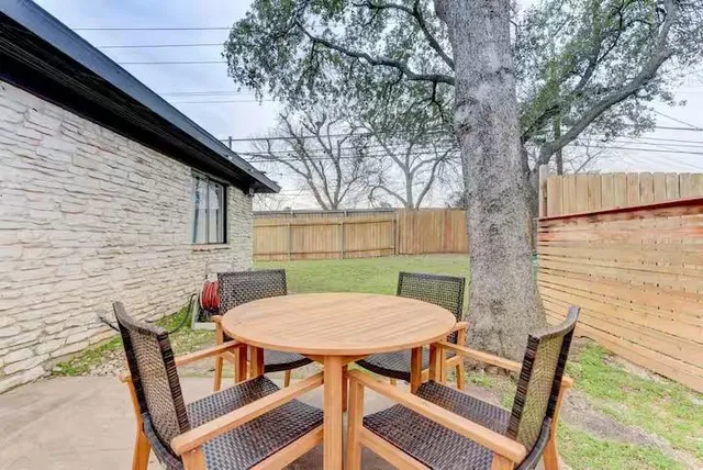 a view of a patio with table and chairs