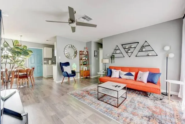 a living room with furniture and wooden floor