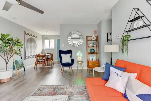 a living room with furniture and wooden floor