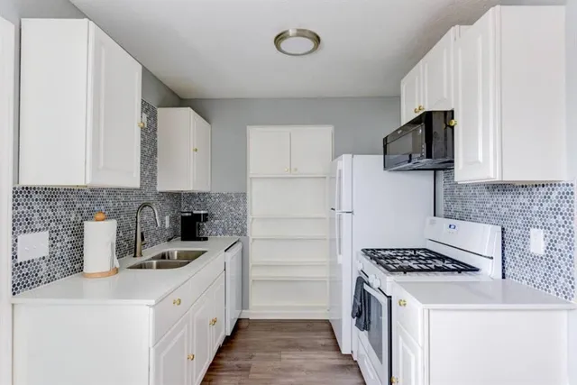a kitchen with a sink and cabinets