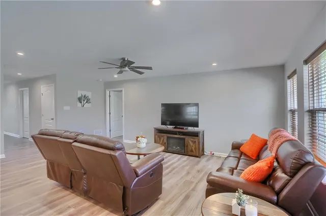 a living room with furniture and a wooden floor