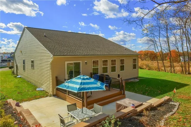 a view of a house with backyard and sitting area
