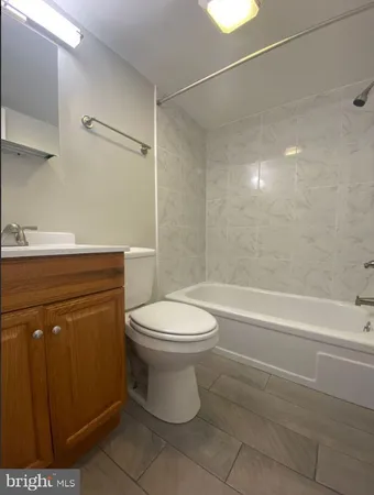a bathroom with a toilet a sink and a shower