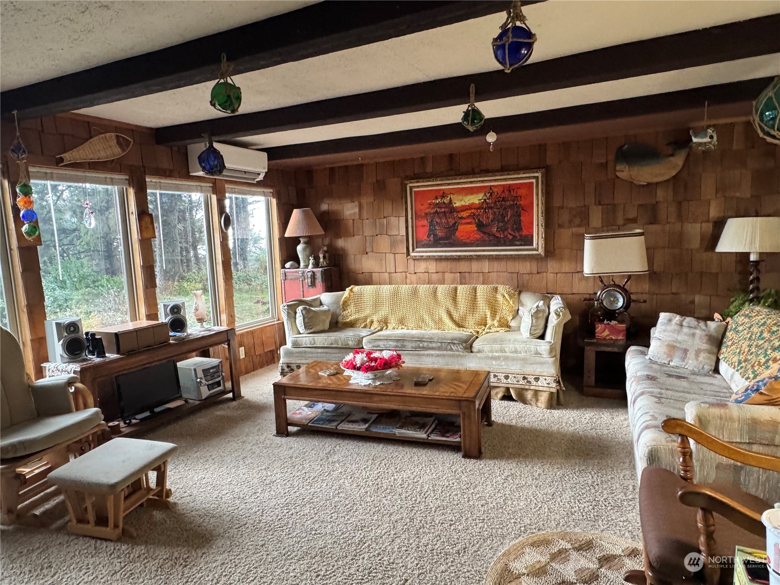 a living room with furniture and a large window