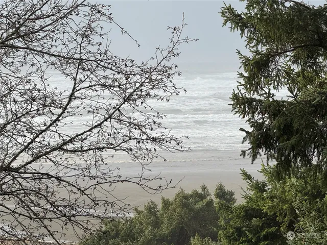 a kitchen with refrigerator a stove a sink and a window with open kitchen view