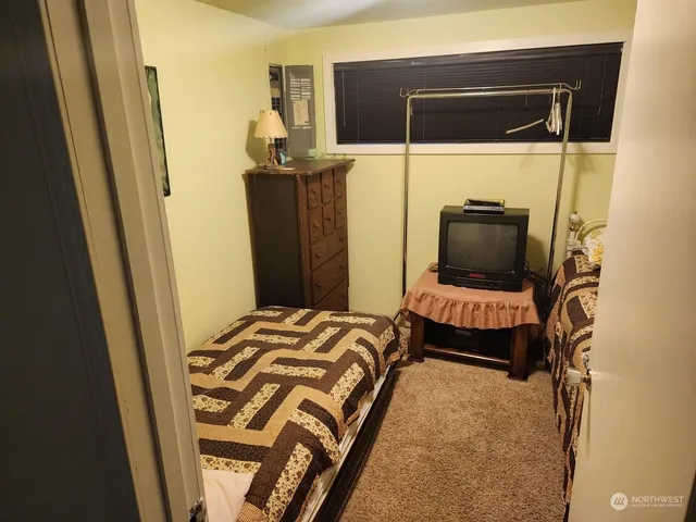 a utility room with wooden floor washer and dryer