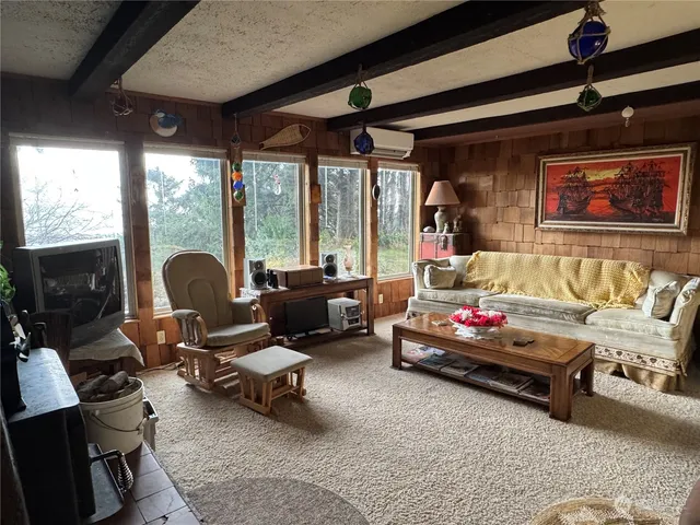 a living room with furniture and a floor to ceiling window