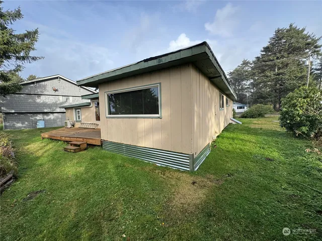 a backyard of a house with table and chairs