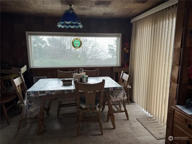 a view of a dining room with furniture window and outside view