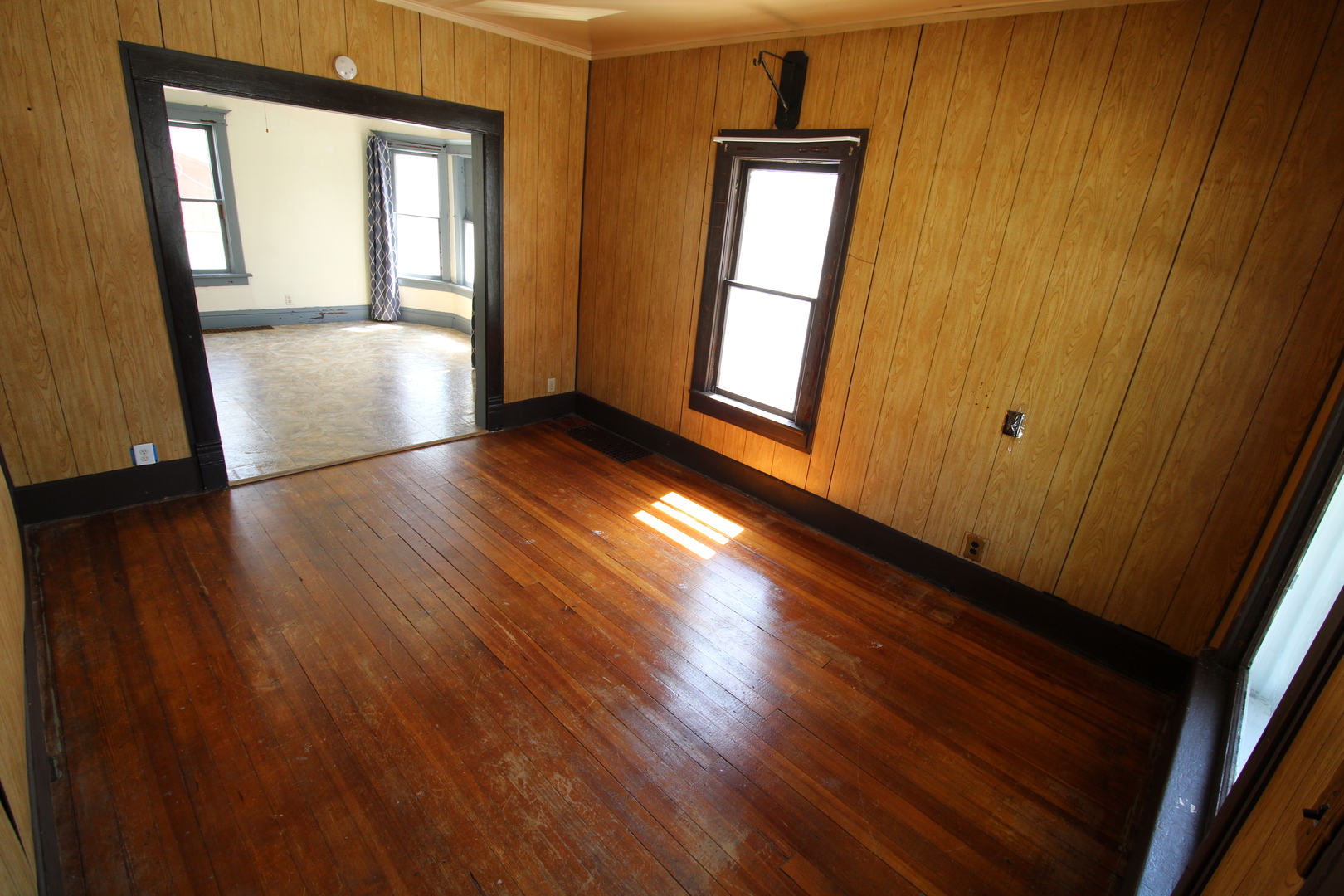 1176 22nd Street Moline, IL 61265 - Photo 3 of 19 a view of an empty room with wooden floor and a window