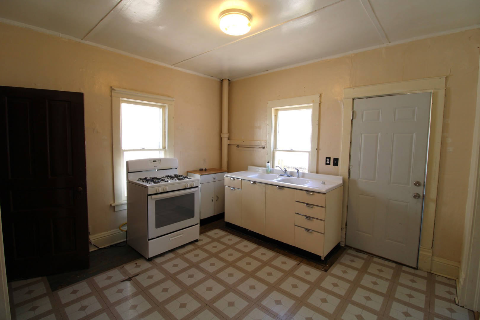 1176 22nd Street Moline, IL 61265 - Photo 7 of 19 a kitchen with a stove cabinets and a window