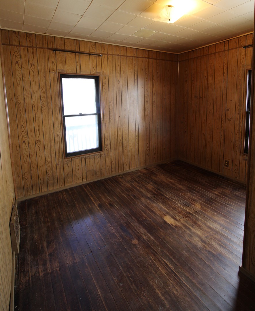 1176 22nd Street Moline, IL 61265 - Photo 8 of 19 an empty room with wooden floor and windows