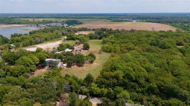 a view of a lake and green valley