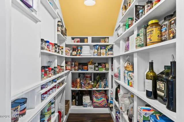 a view of a wooden bench sitting in middle of a yard