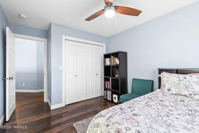 a bedroom with a bed a flat screen tv and dresser