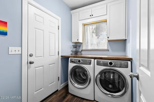 a view of a backyard with a table and chairs under an umbrella