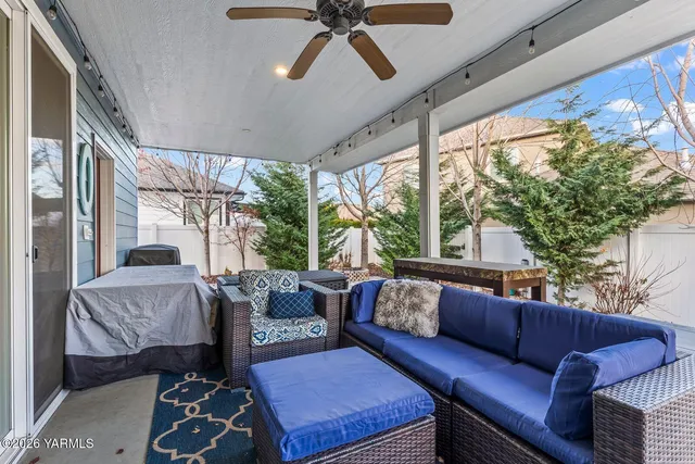 a front view of house with yard and trees in the background