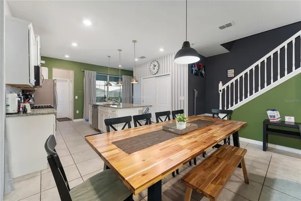 a kitchen with a sink a counter space and a view of living room