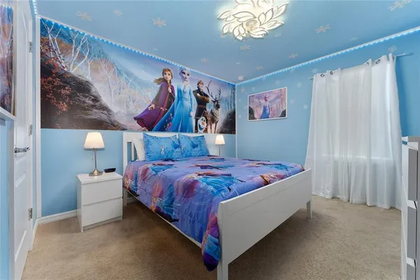 a bedroom with a bed and wall paintings