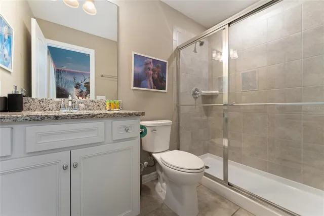 a spacious bathroom with a mirror a shower and a sink