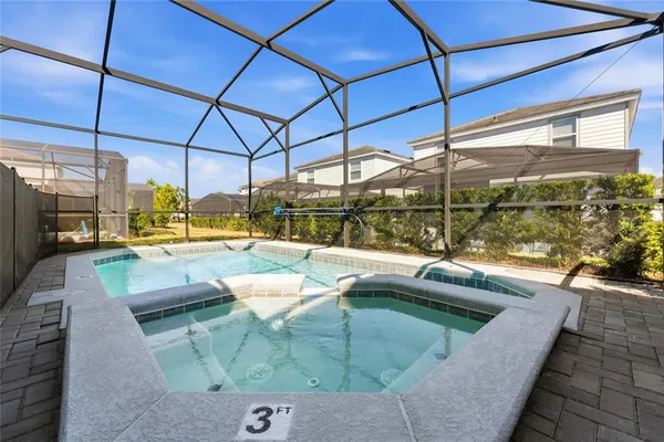 an aerial view of a multi story residential apartment building in front of residential houses with outdoor space