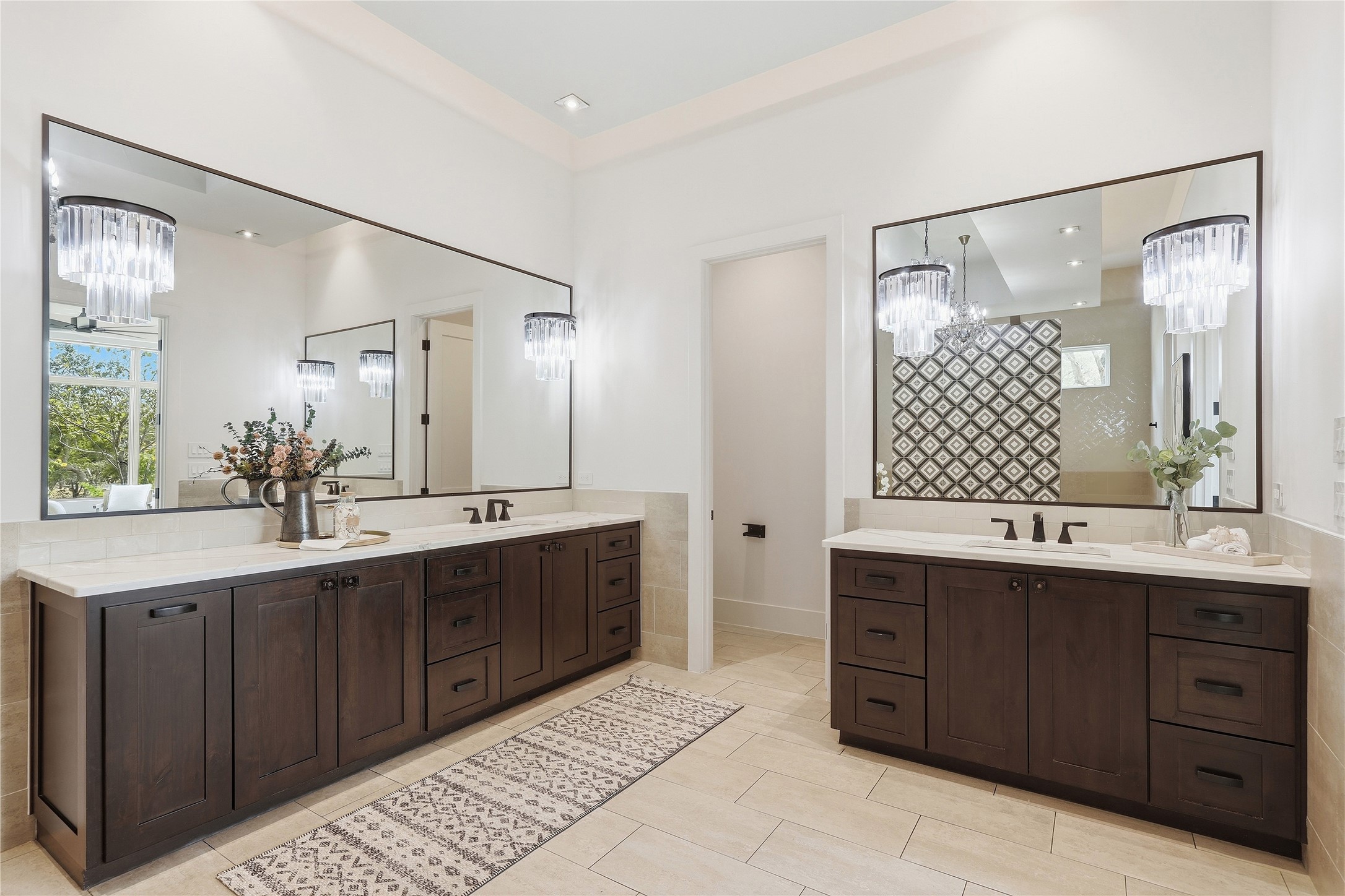 449 Ranch Falls Fair Oaks Ranch, TX 78015 - Photo 22 of 39 Rich dark wood vanities contrast elegantly against light tiled flooring and crisp neutral walls.
