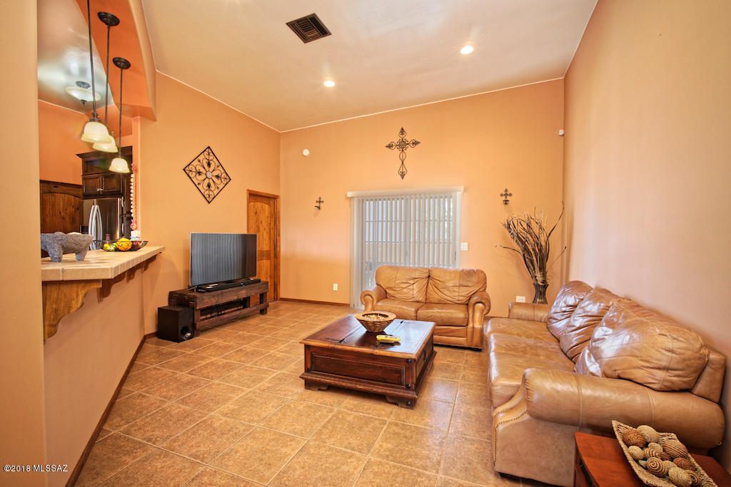 1721 Camino Jalisco Rio Rico, AZ 85648 - Photo 4 of 39 a living room with furniture and a flat screen tv