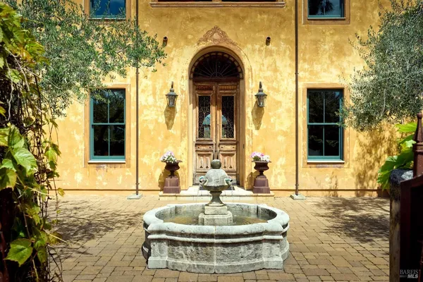 a view of a patio with table and chairs and potted plants