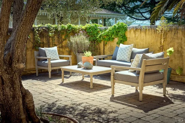 a view of a patio with a table chairs and a fire pit