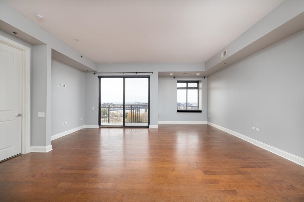 717 Riverside Drive, Unit 1105 Memphis, TN 38103 - Photo 11 of 29 Unfurnished room with dark wood-type flooring