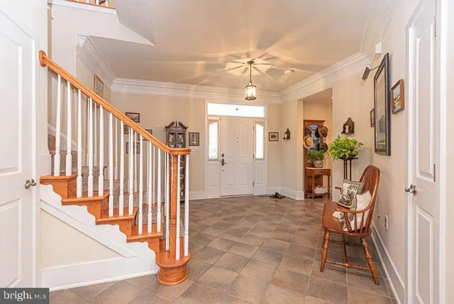 a living room with furniture kitchen view and a chandelier