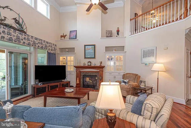 a view of a livingroom with wooden floor and stairs