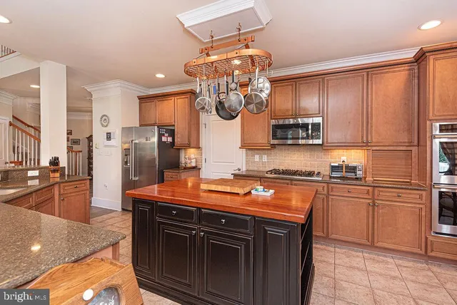 an aerial view of a swimming pool with lawn chairs and a yard