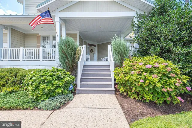 a view of a patio with a dining table and chairs with wooden floor