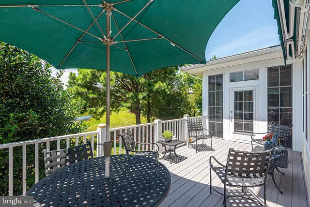 an aerial view of a house with a garden and lake view