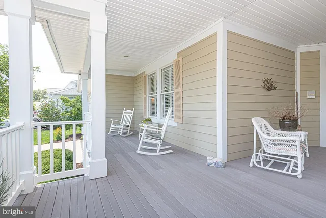 a living room with furniture a computer and a window