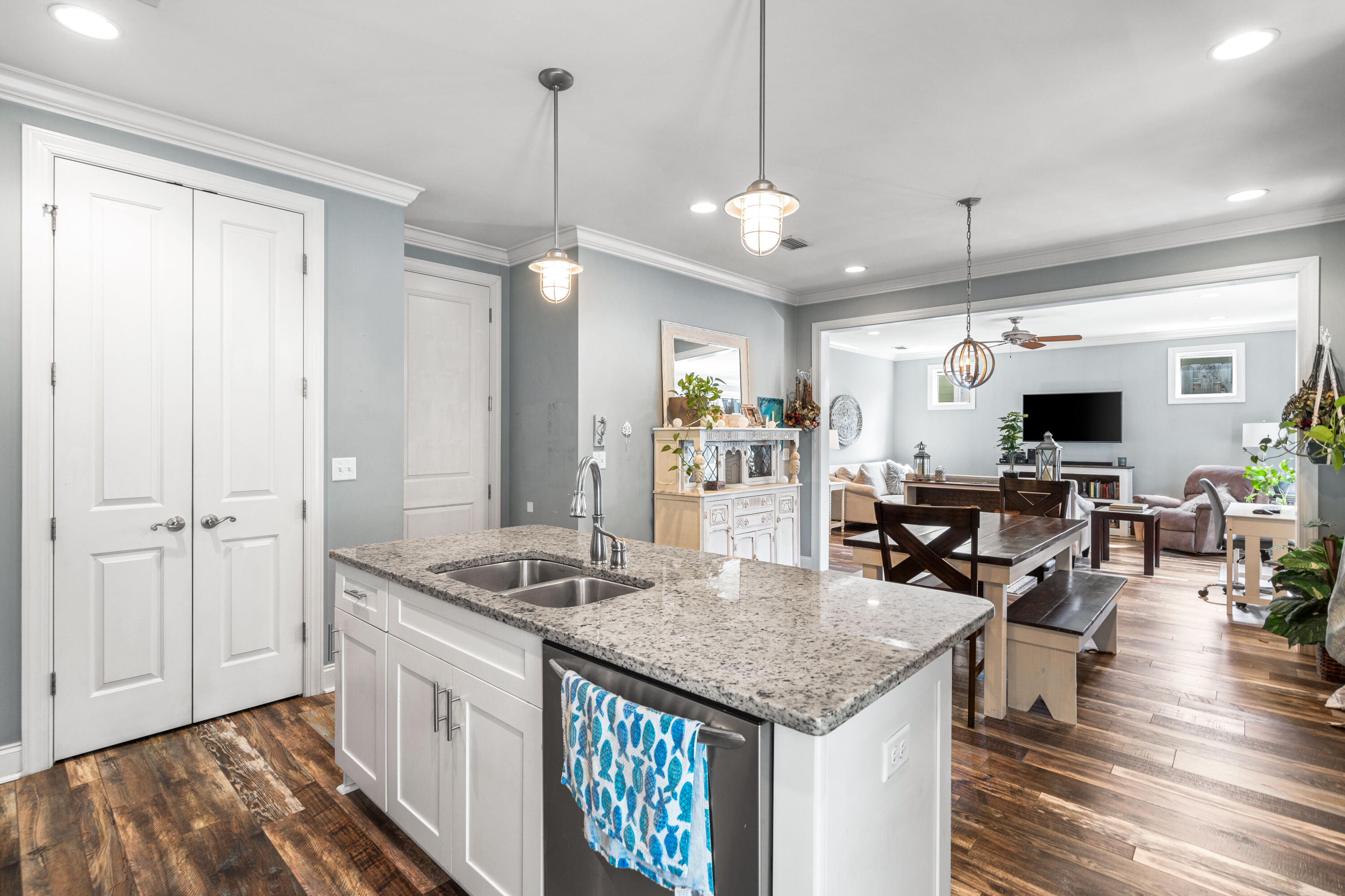 83 Hatton Court Santa Rosa Beach, FL 32459 - Photo 11 of 42 a kitchen with stainless steel appliances granite countertop a stove oven and a dining table with wooden floor