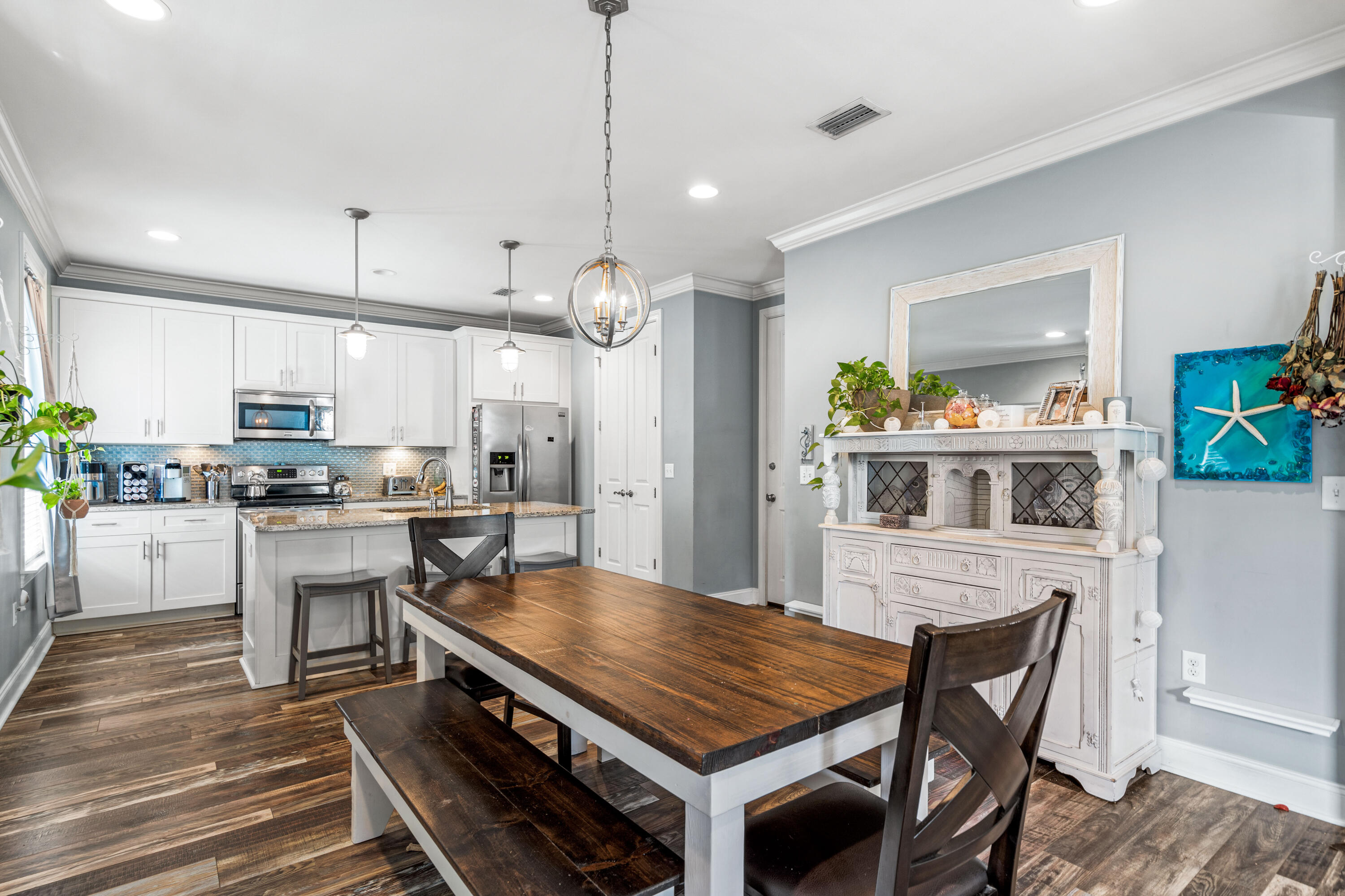 83 Hatton Court Santa Rosa Beach, FL 32459 - Photo 6 of 42 a kitchen with kitchen island a stove a table and chairs in it