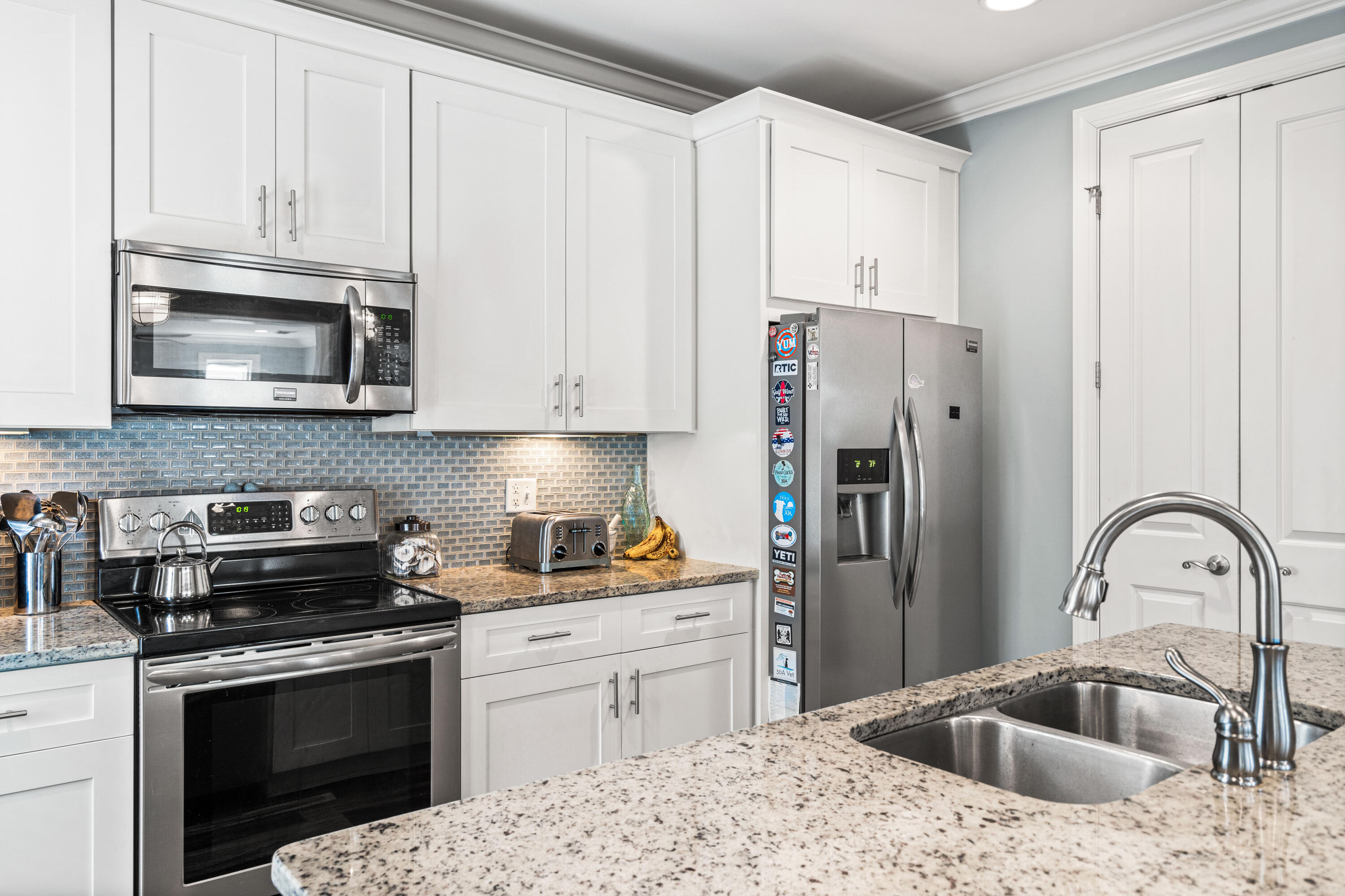 83 Hatton Court Santa Rosa Beach, FL 32459 - Photo 10 of 42 a kitchen with stainless steel appliances granite countertop a stove a refrigerator and a sink