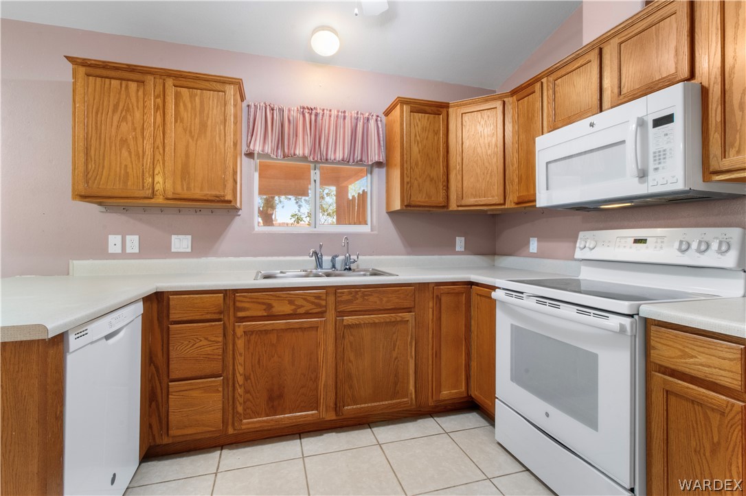 2158 Ranch Road Kingman, AZ 86401 - Photo 8 of 48 a kitchen with stainless steel appliances granite countertop a sink stove and cabinets