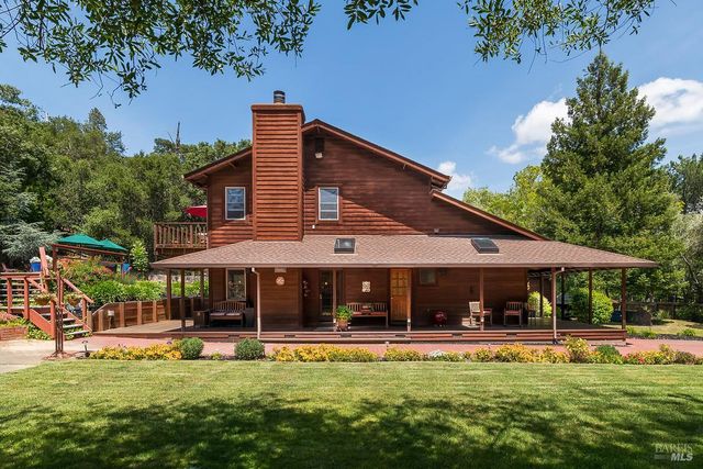 a view of a house with swimming pool and sitting area