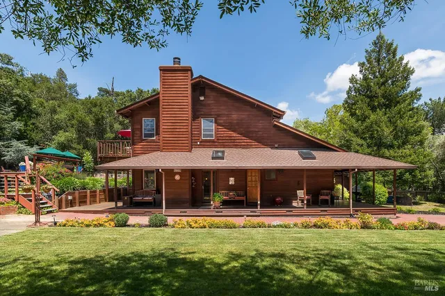 a view of a house with swimming pool and sitting area