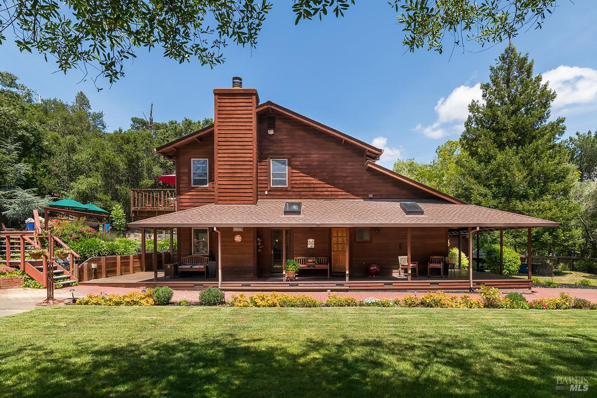 a view of a house with swimming pool and sitting area
