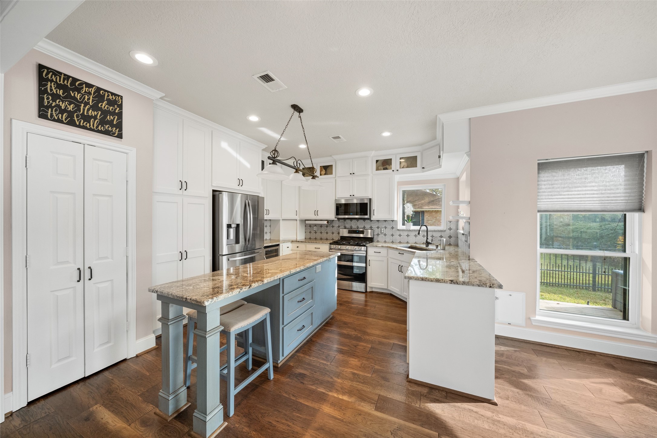 20256 Ivy Point Circle Humble, TX 77346 - Photo 16 of 36 a large kitchen with stainless steel appliances kitchen island a large counter top and a wooden floors
