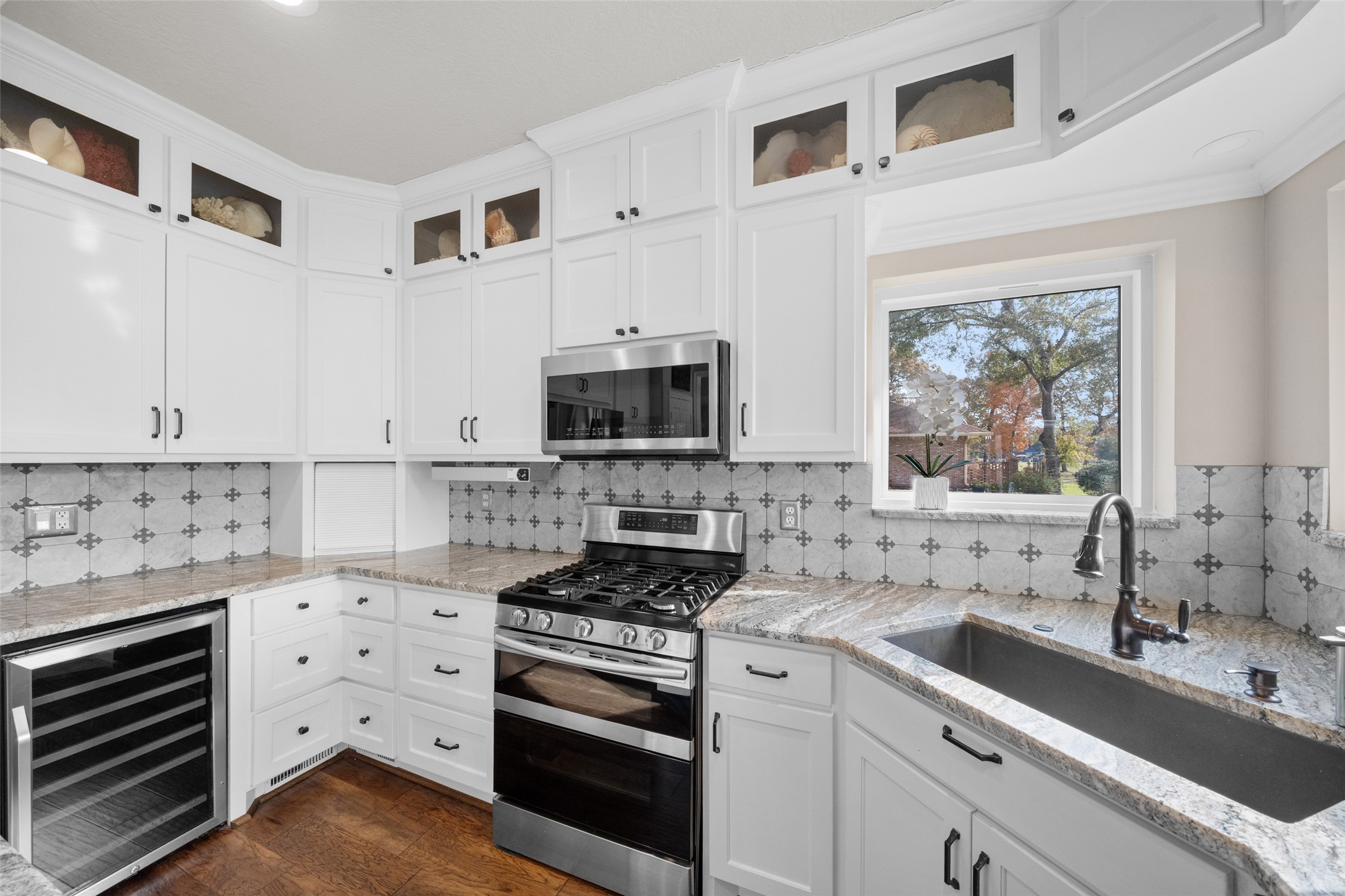20256 Ivy Point Circle Humble, TX 77346 - Photo 17 of 36 a kitchen with stainless steel appliances a stove sink and cabinets