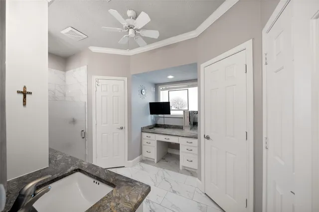 a bathroom with a granite countertop sink toilet a mirror a vanity and shower