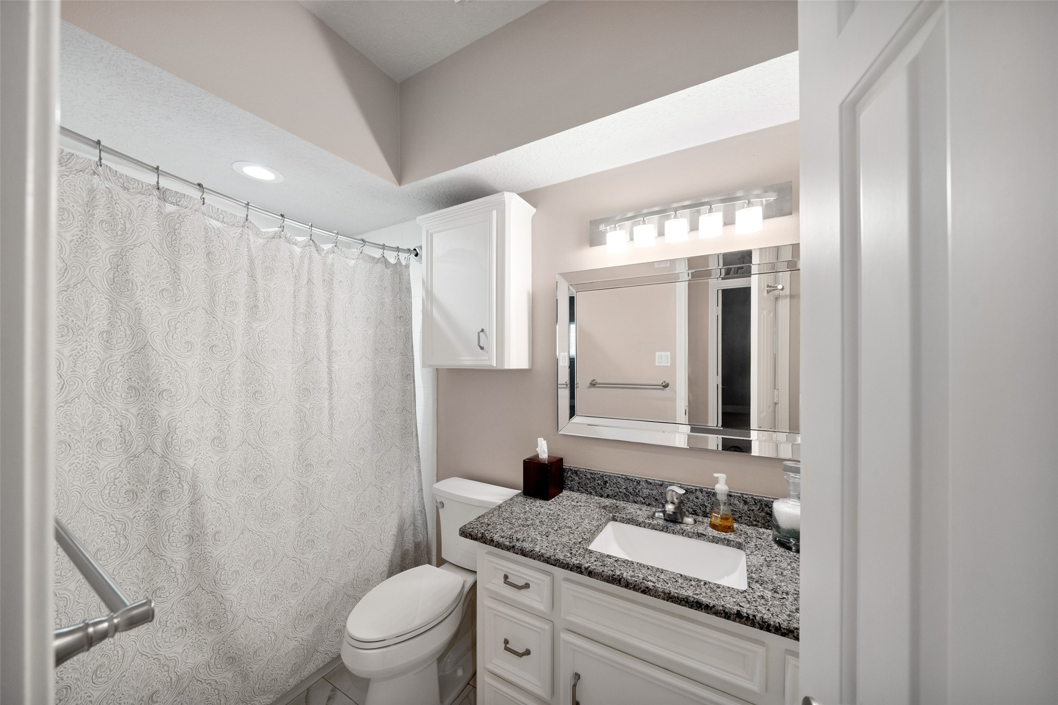 20256 Ivy Point Circle Humble, TX 77346 - Photo 26 of 36 a bathroom with a granite countertop sink toilet a mirror a vanity and shower