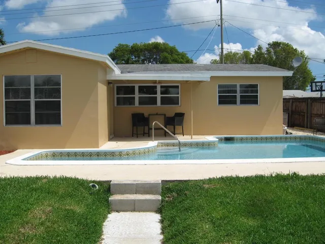 a front view of a house with a garden and plants