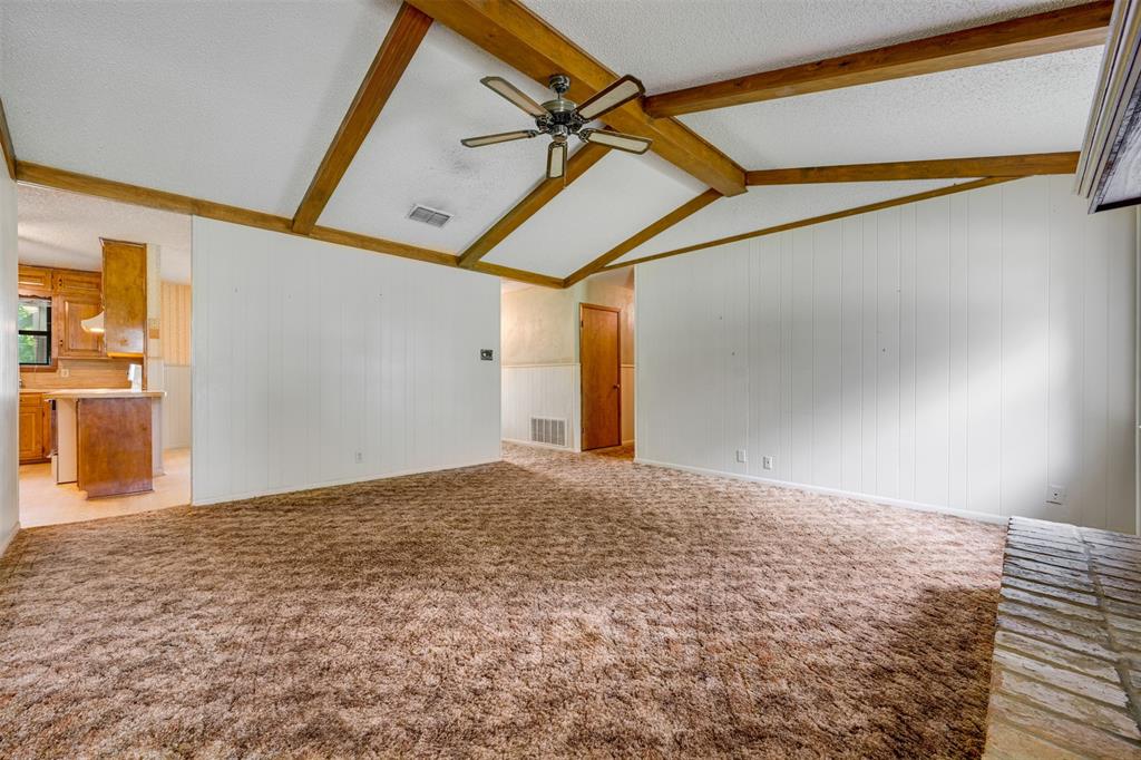 8798 Hill N Dale Road Tyler, TX 75709 - Photo 7 of 31 Vaulted ceiling with exposed wood beams and a ceiling fan